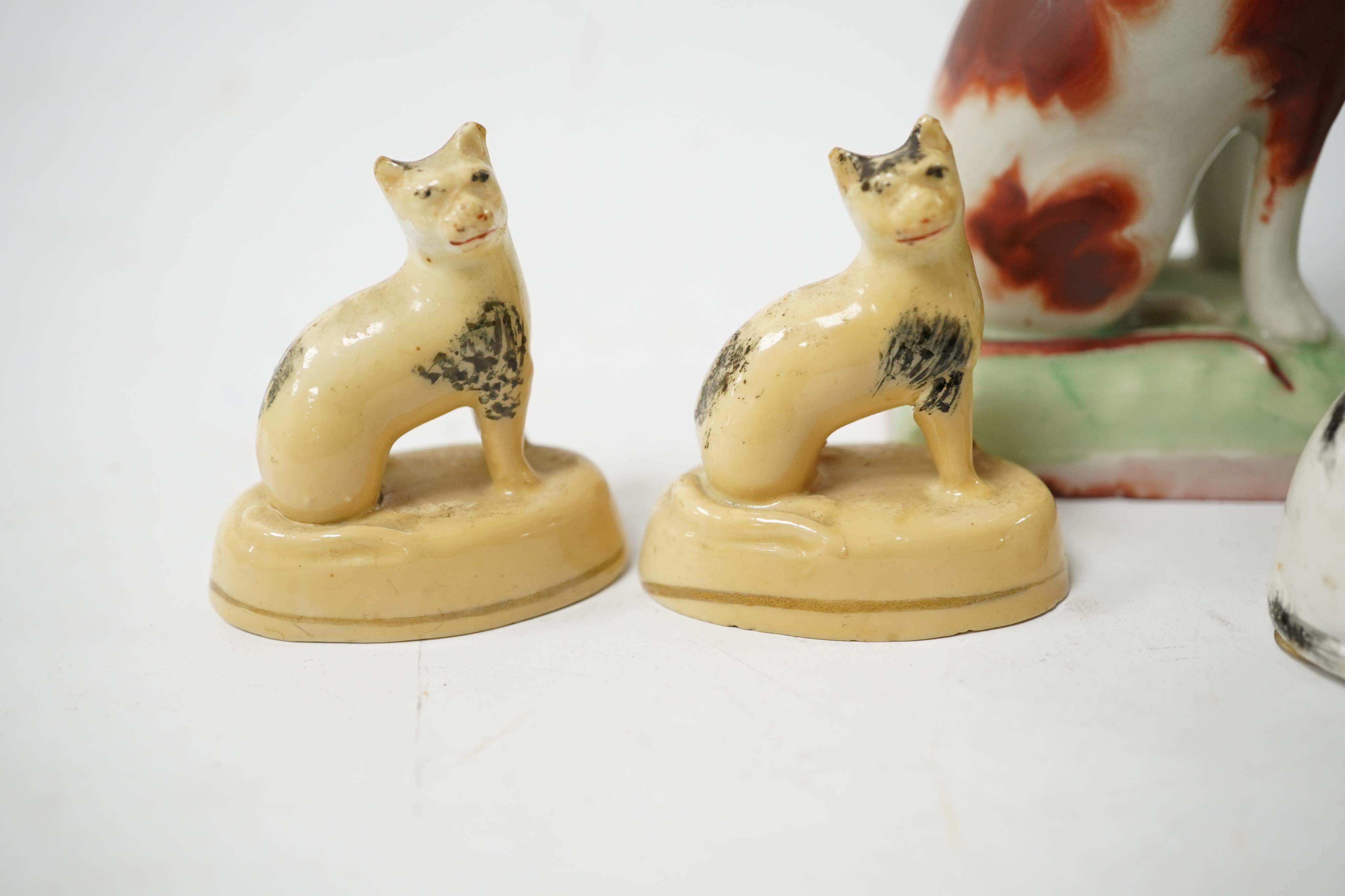 Five rare Staffordshire porcelain models of cats, circa 1830-50, including a group of a cat and kitten, together with a pair of late Staffordshire porcellaneous cats, Condition - restoration to three of the cats and a cr